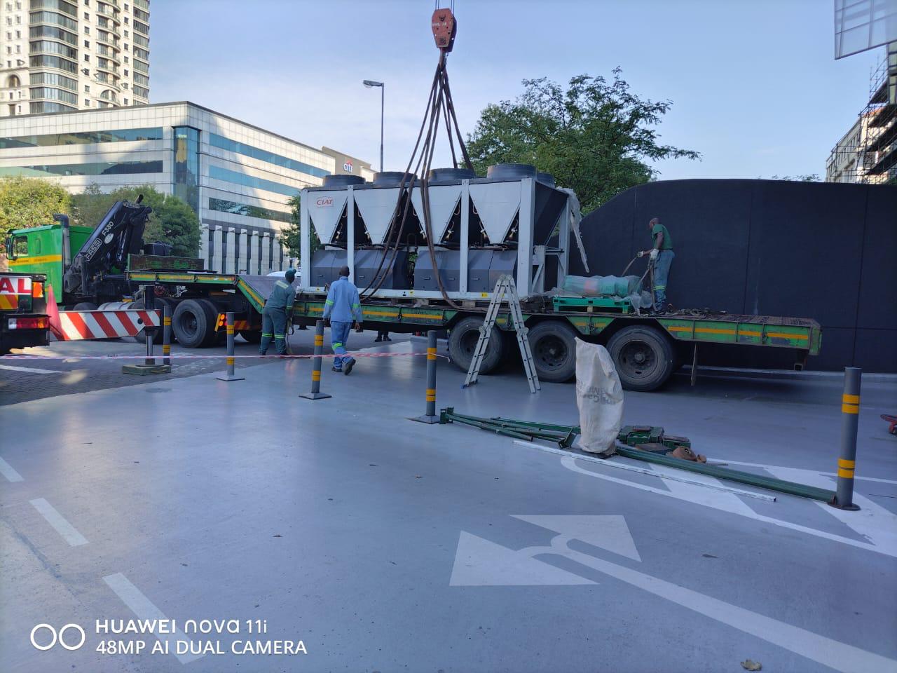 Flatbed truck transporting new cooling towers to site