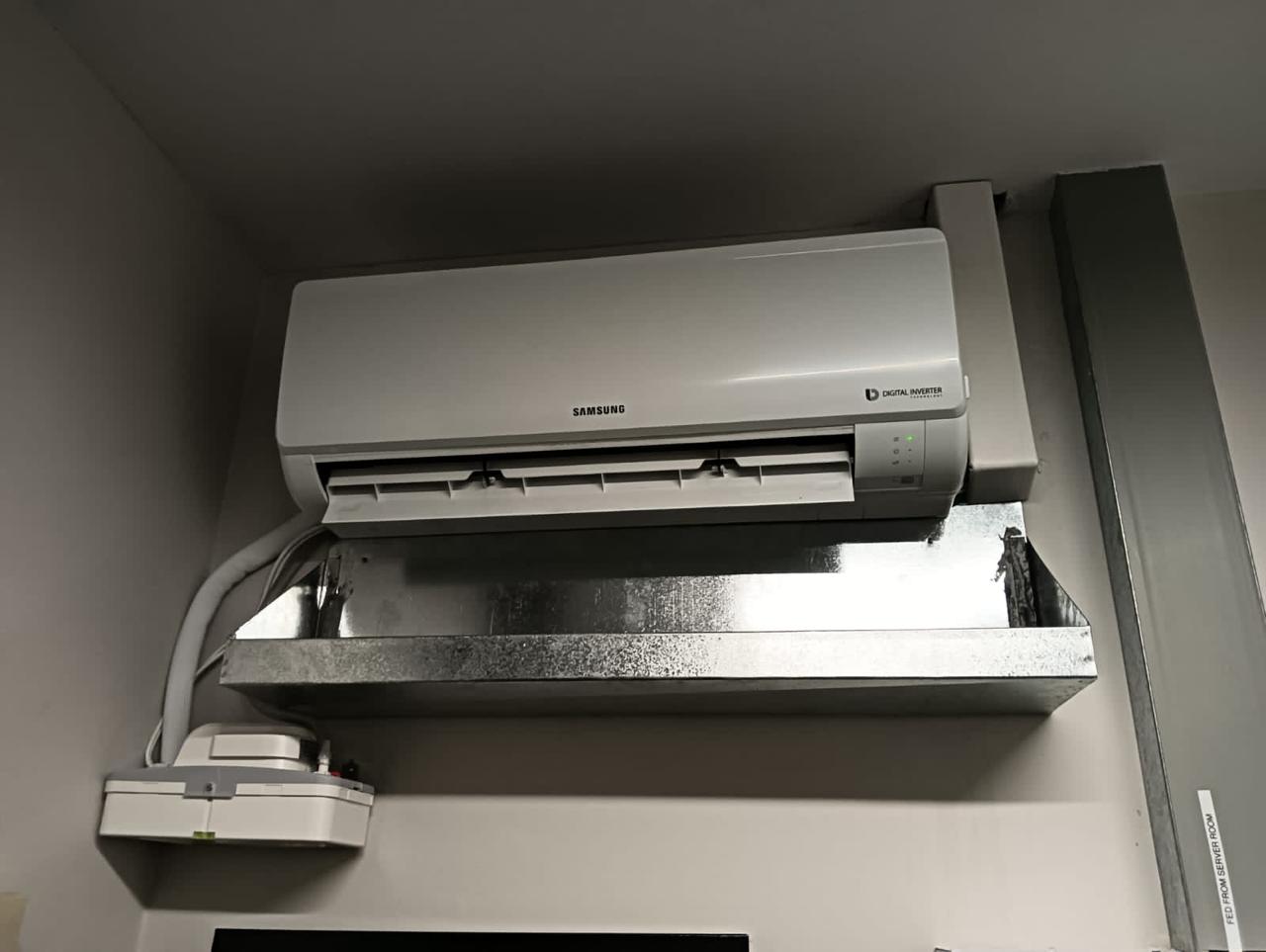 Wall-mounted split air conditioner with condensate drip tray