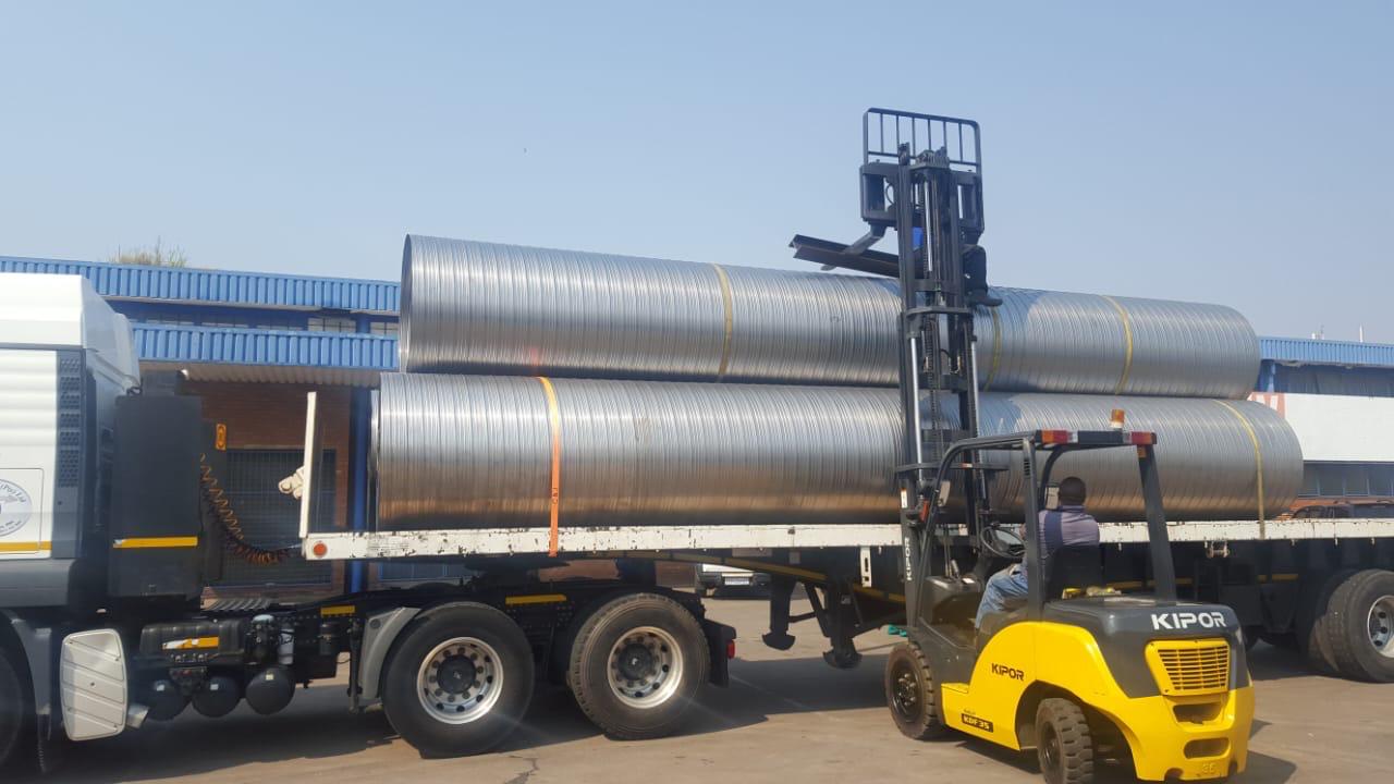 Forklift loading spiral ducting onto a truck for delivery