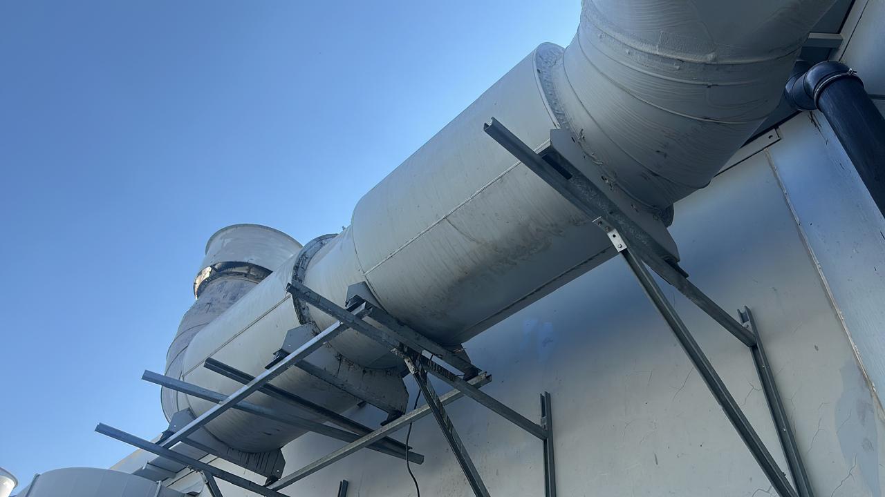 Large-diameter spiral ducting run across a rooftop plant area