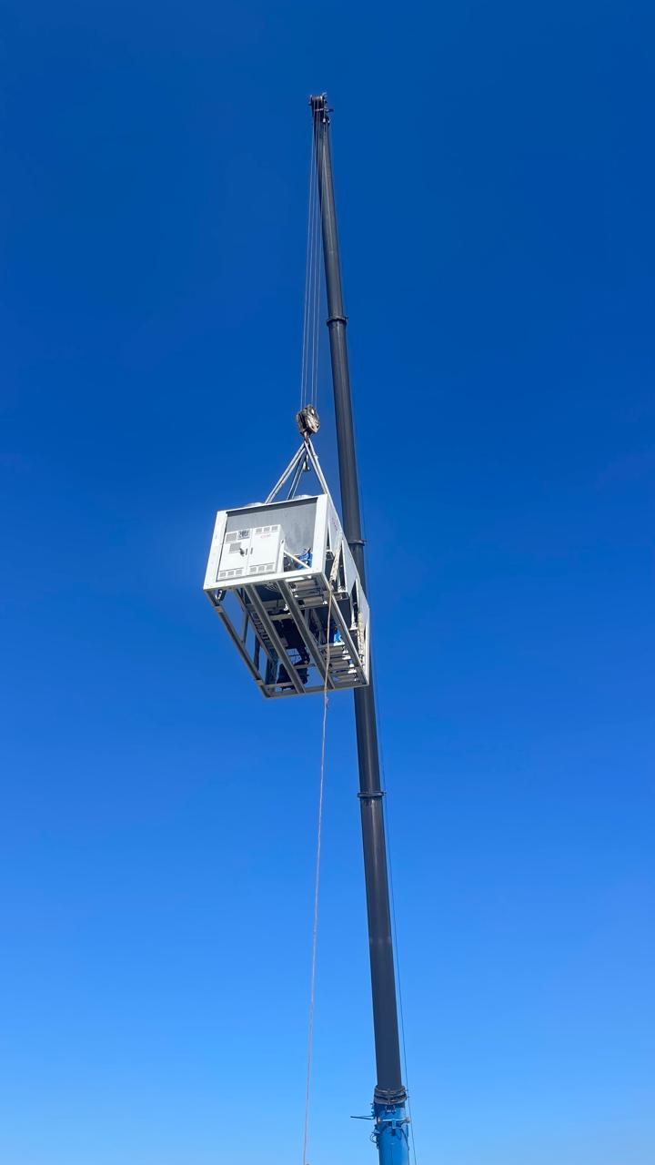 Framed plant unit raised high on a crane line