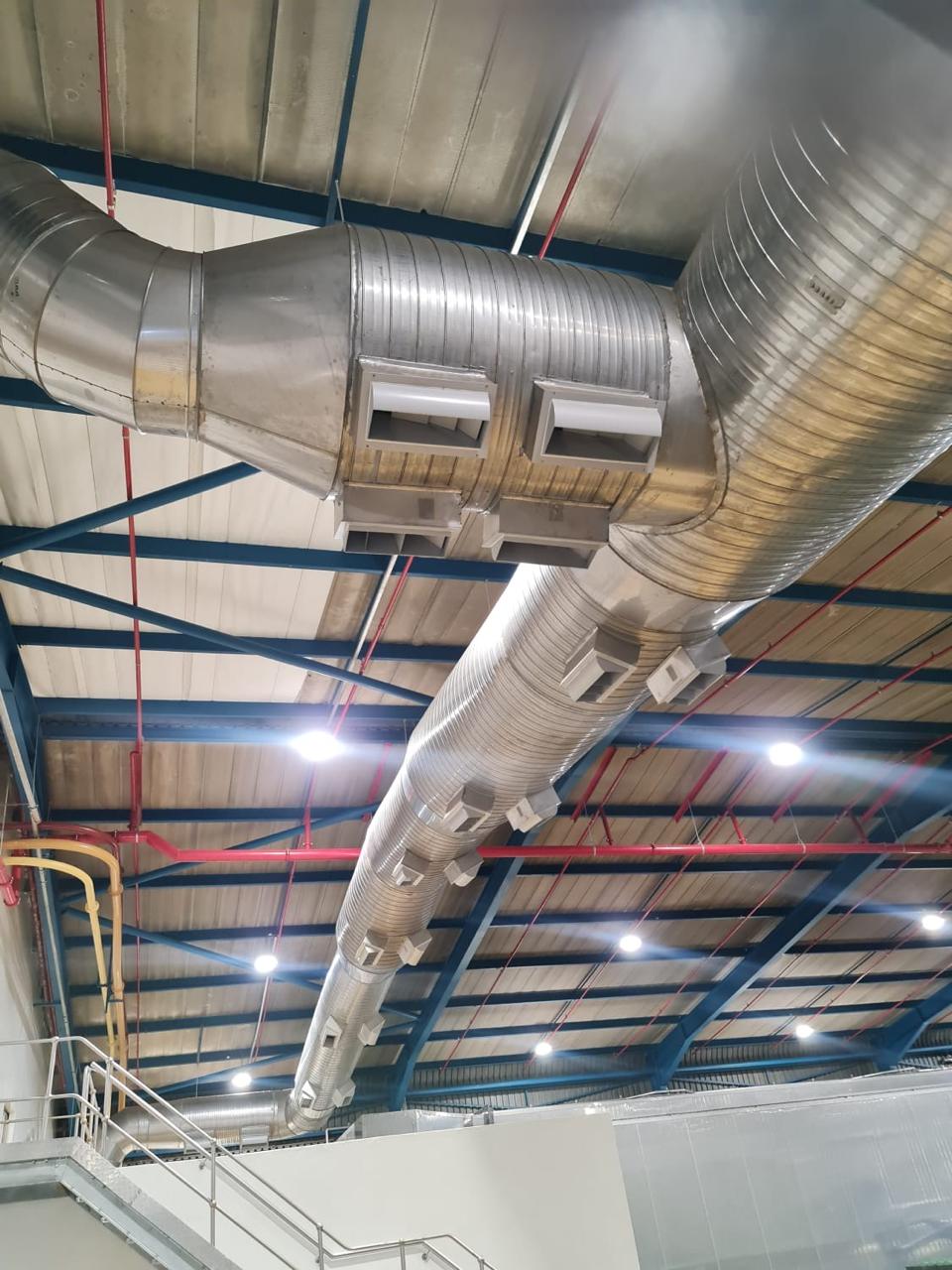 Spiral ducting with diffusers along a warehouse roof structure